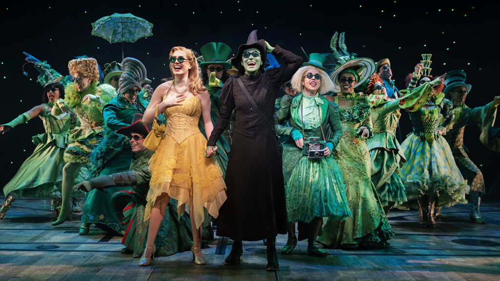 McKenzie Kurtz, Alyssa Fox, and the cast of Wicked. Photo by Joan Marcus.