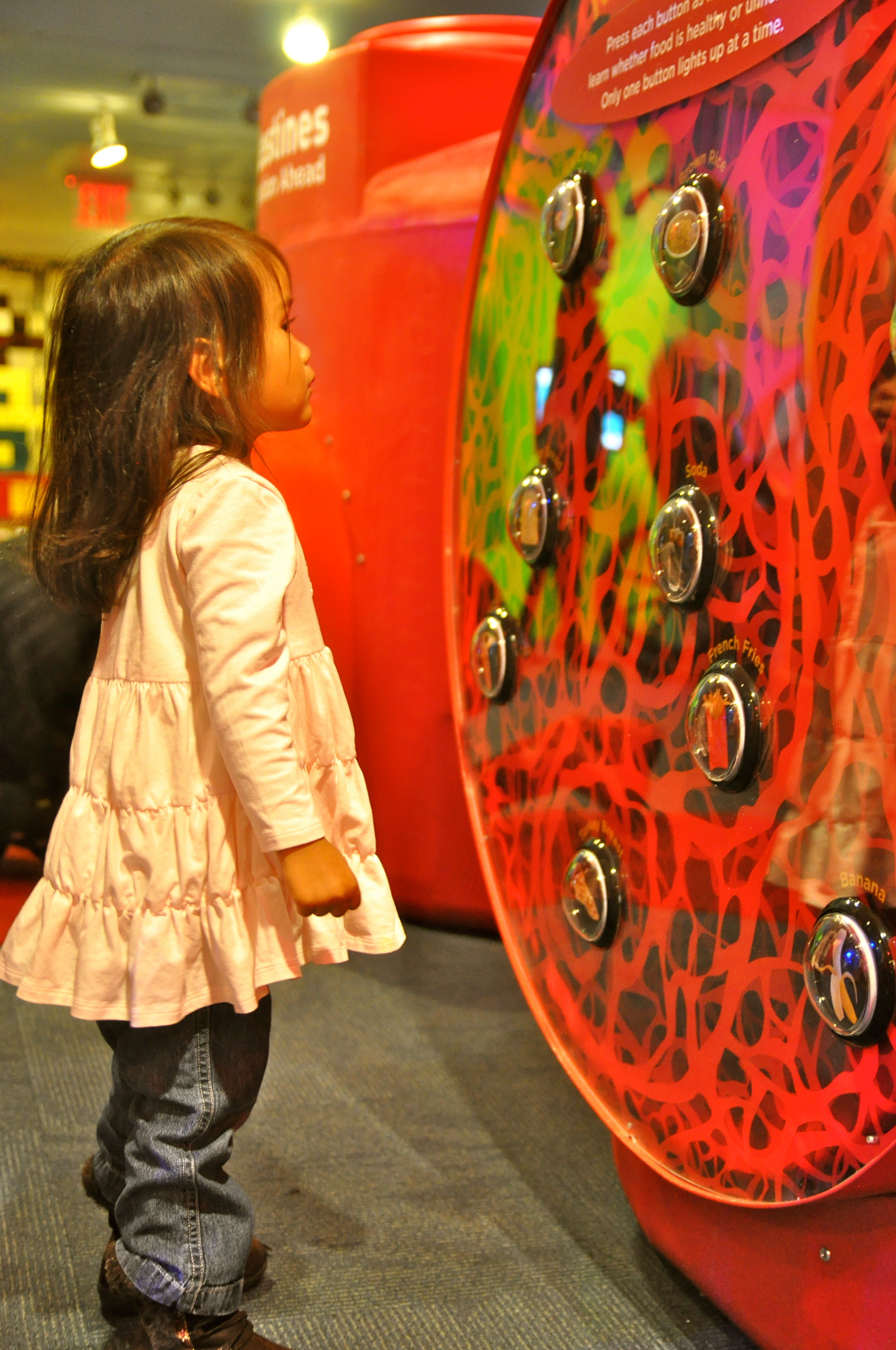 Young girl looking at red circle as a museum