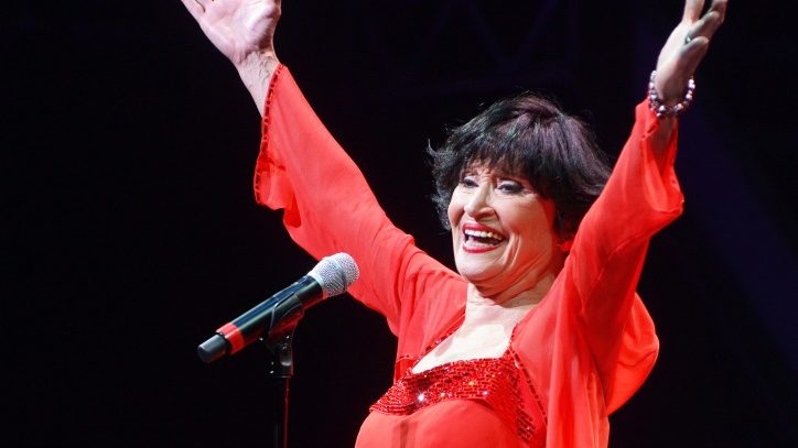 Chita Rivera performing on stage in a red dress