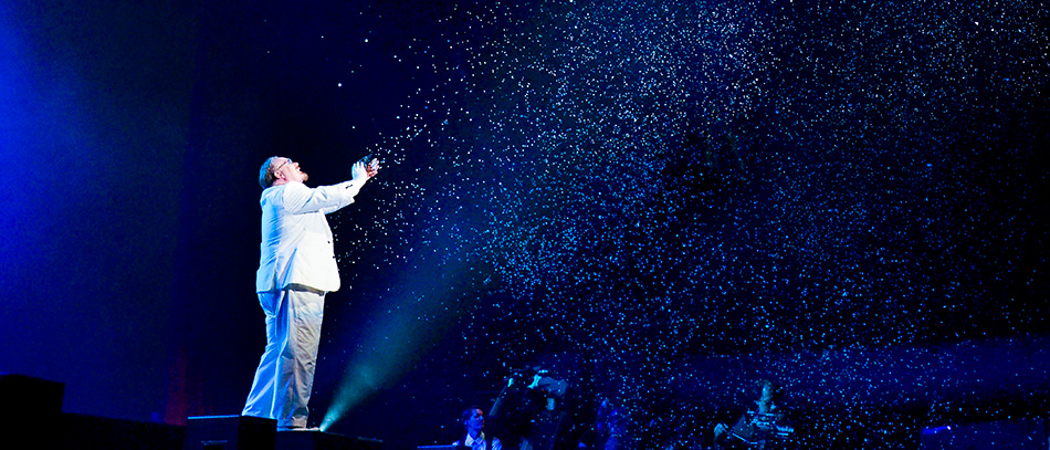 A photo of a magician in the Broadway show The Illusionists throwing confetti in the air