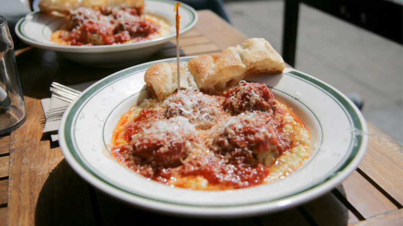 The Meatball Shop's chicken meatballs served over polenta and topped with tomato sauce.