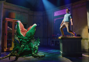 Conrad Ricamora and "Audrey II" in <i>Little Shop of Horrors</i>. Photo by Emilio Madrid.