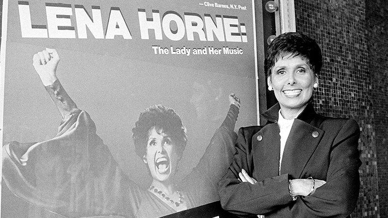 Actress-singer Lena Horne poses next to a poster advertising her one-woman show, “Lena Horne: The Lady and Her Music,” at the Pantages Theatre in Hollywood, Ca., November 15, 1982. (AP Photo/Doug Pizac)