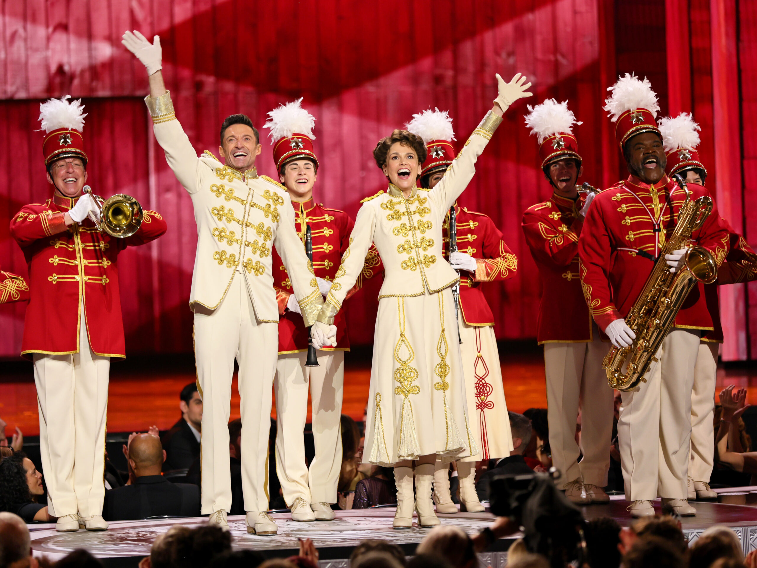 Aydin Eyikan behind Hugh Jackman and Sutton Foster at the 75th Annual Tony Awards at Radio City Music Hall on June 12, 2022 in New York City. Photo by Theo Wargo/Getty Images for Tony Awards Productions.
