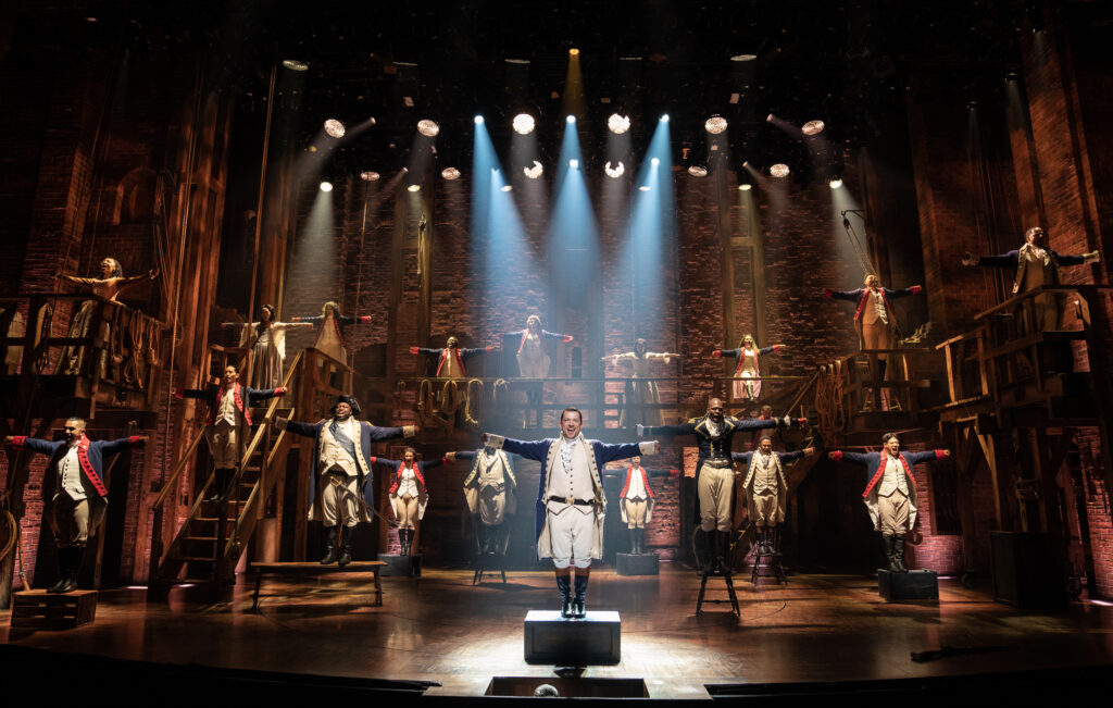 Miguel Cervantes and the cast of Hamilton. Photo by Joan Marcus.