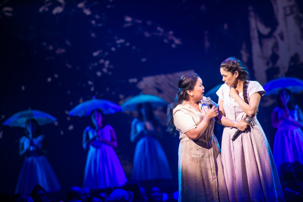 Melody Butiu, Arielle Jacobs, and the cast of Here Lies Love. Photo by Billy Bustamante, Matthew Murphy, and Evan Zimmerman.