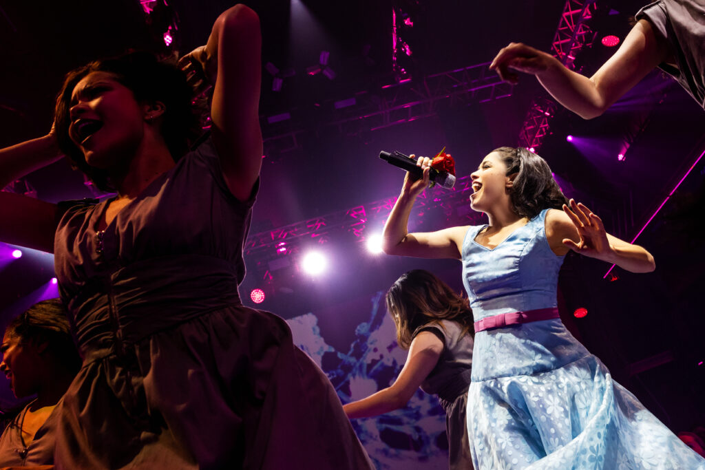 Arielle Jacobs and the cast of Here Lies Love. Photo by Billy Bustamante, Matthew Murphy, and Evan Zimmerman.