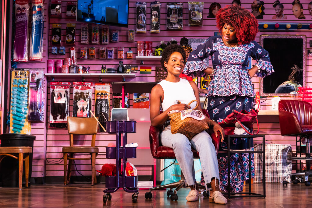 Rachel Christopher and Zenzi Williams in Jaja’s African Hair Braiding. Photo by Matthew Murphy.