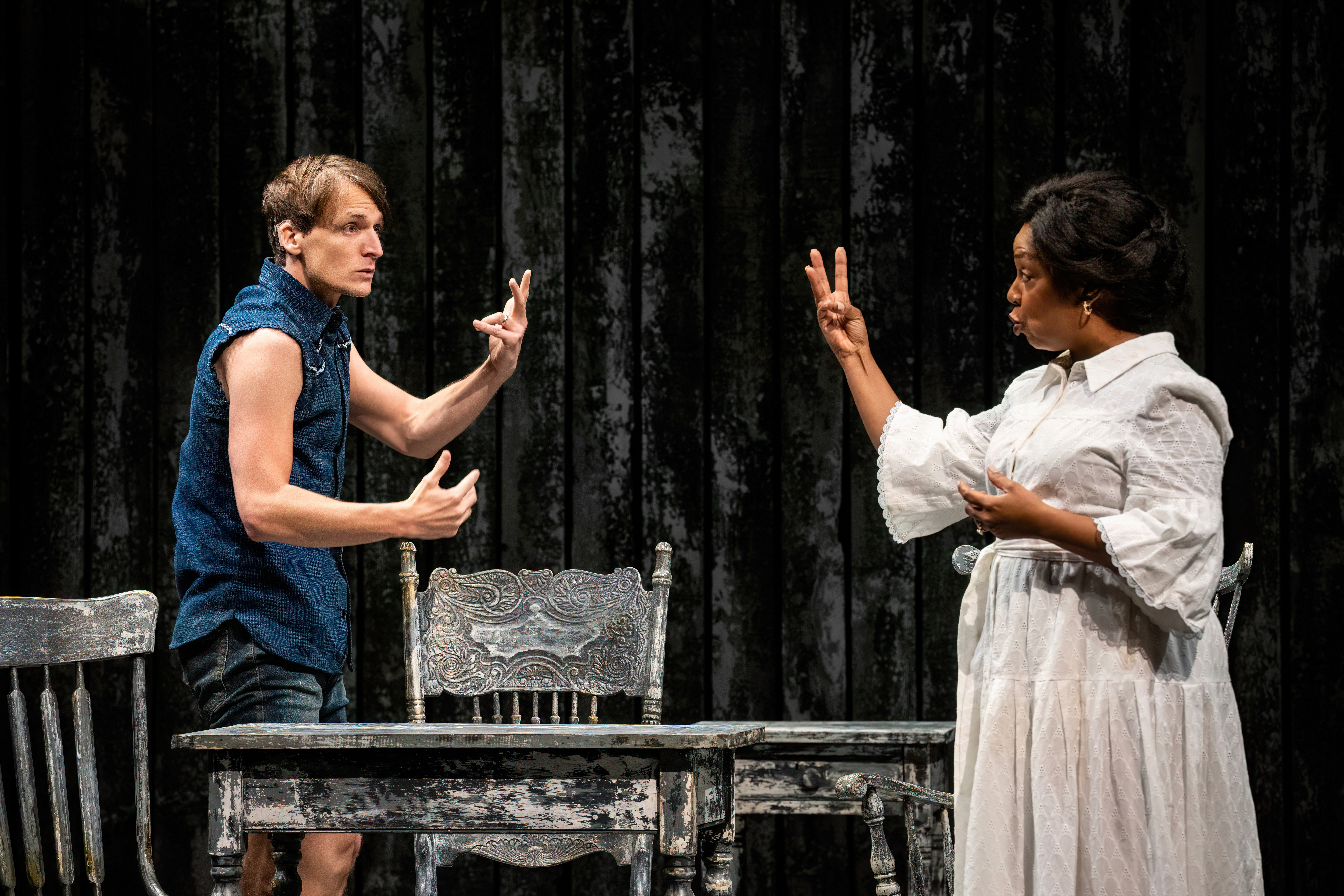 Two characters looking at each other, one holding up two fingers and the other holding up three fingers