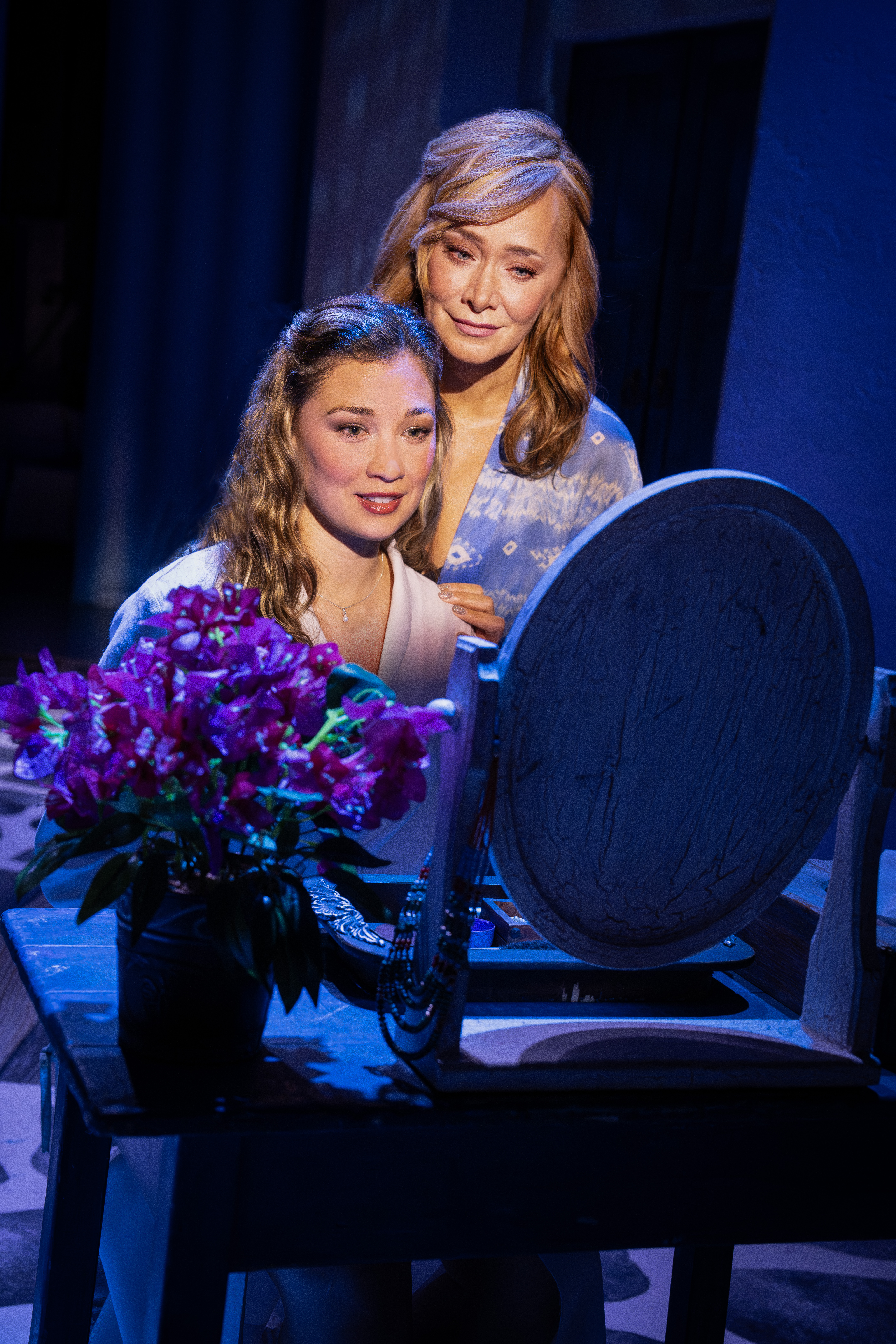 Amy Weaver and Christine Sherrill looking into a mirror in MAMMA MIA!