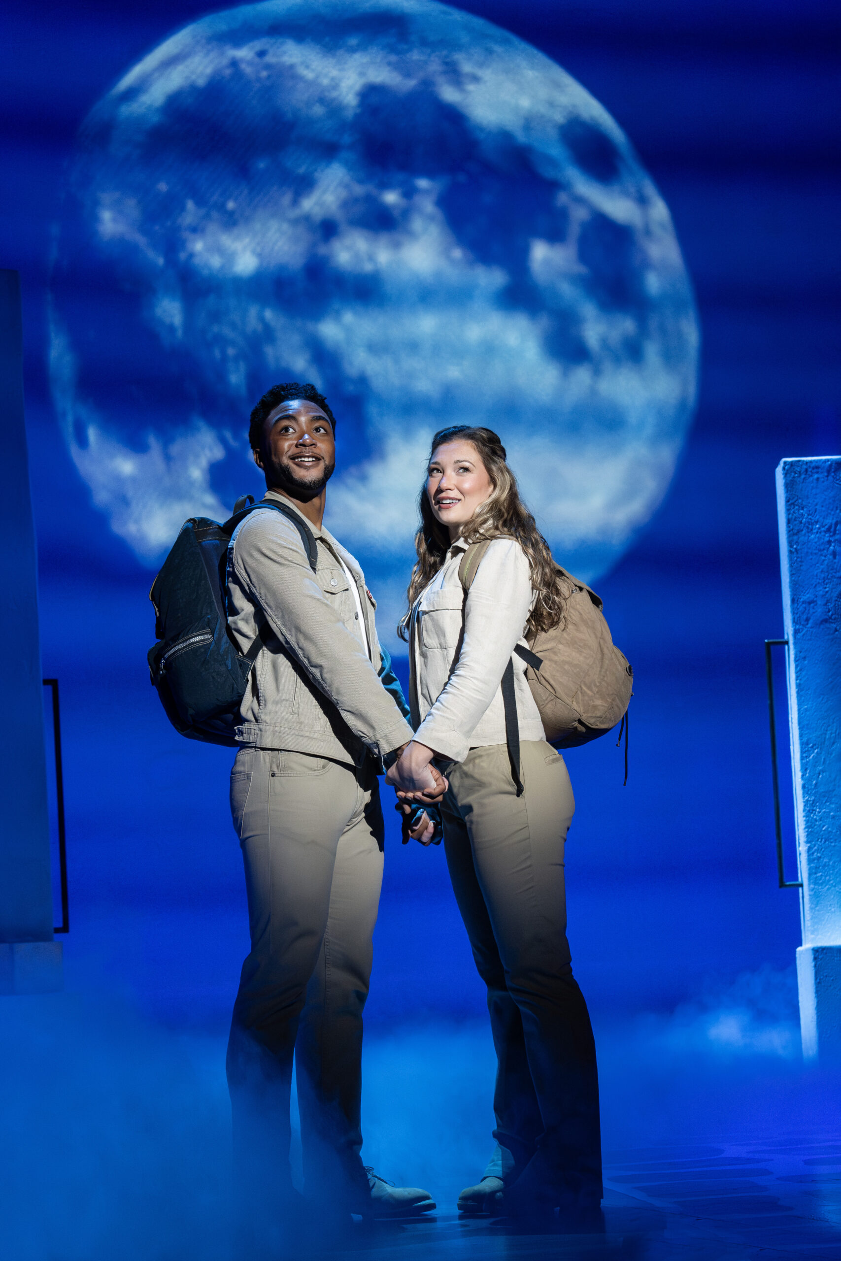 Grant Reynolds and Amy Weaver holding hands in MAMMA MIA!.