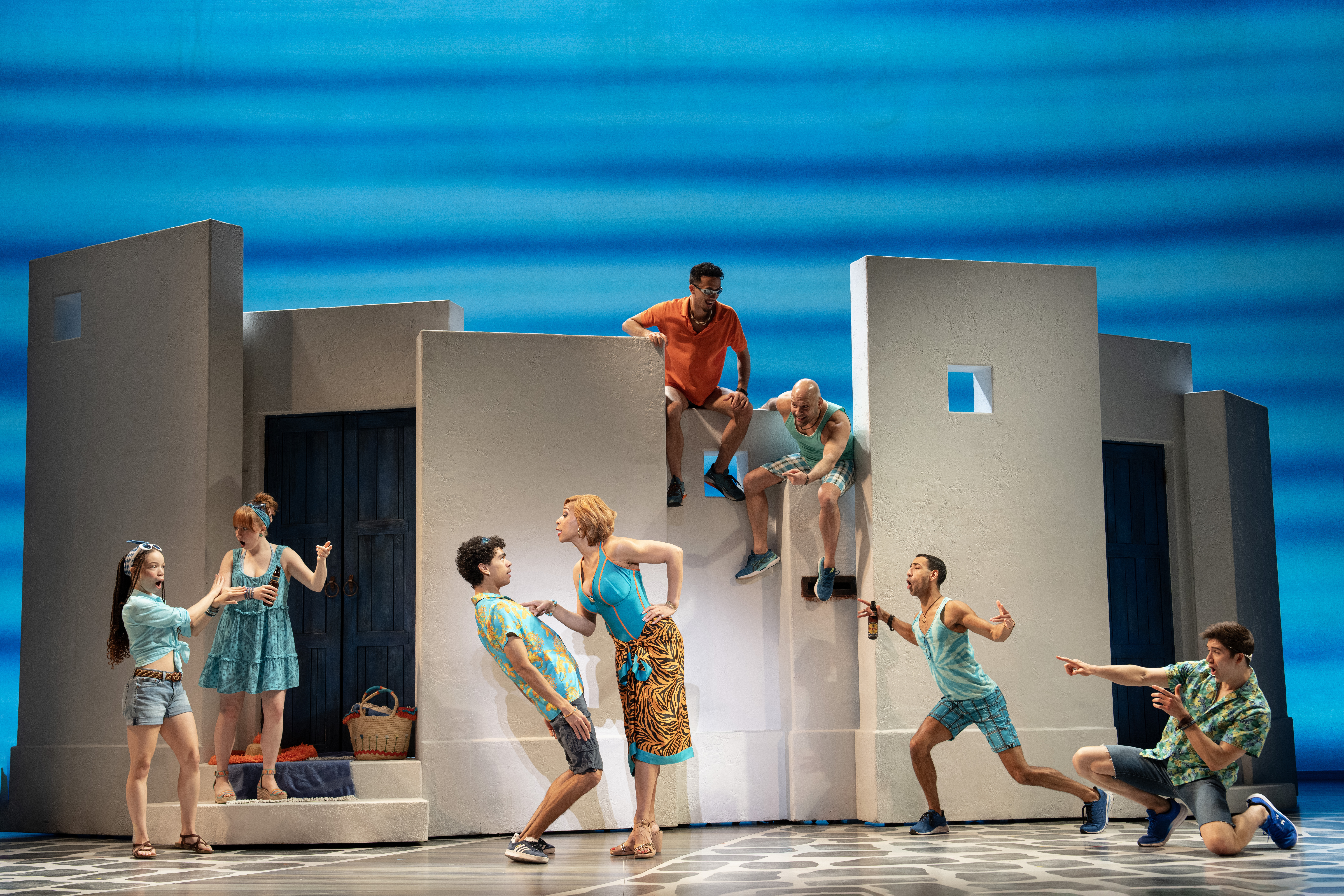 Jalyn Steele pointing at Justin Sudderth surrounded by the Company of MAMMA MIA!